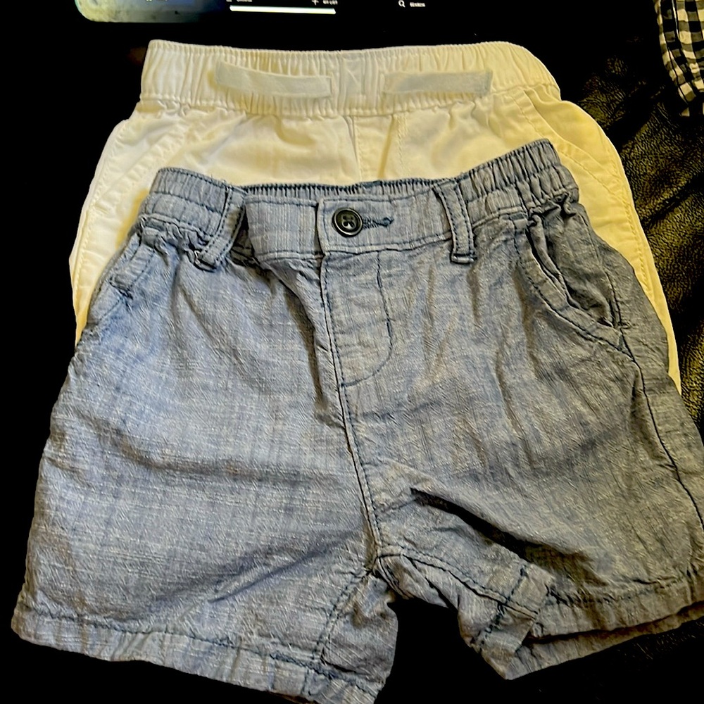 A pair of Children’s Place 12—18 months  shorts. colors are denim and white.